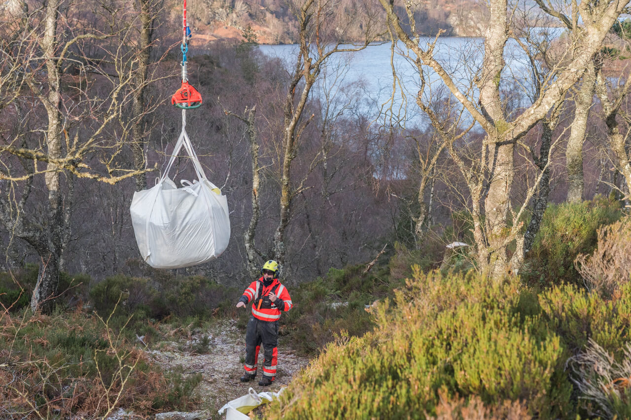 Helicopter lowers bag onto the new path