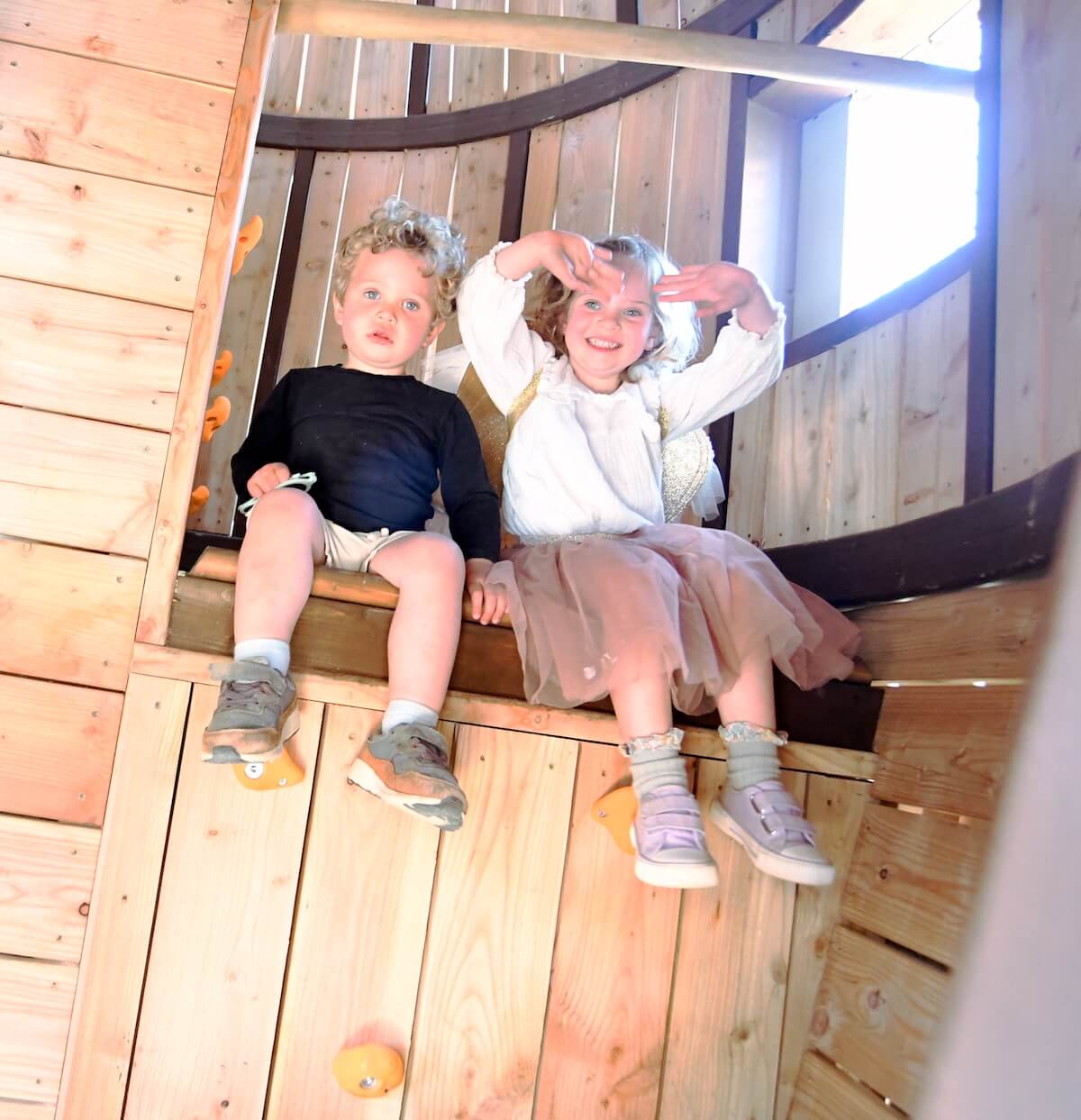 Two kids climbing inside the giant mushroom at Fairy Dell with adventure play by CAP.Co at Fairytale Farm