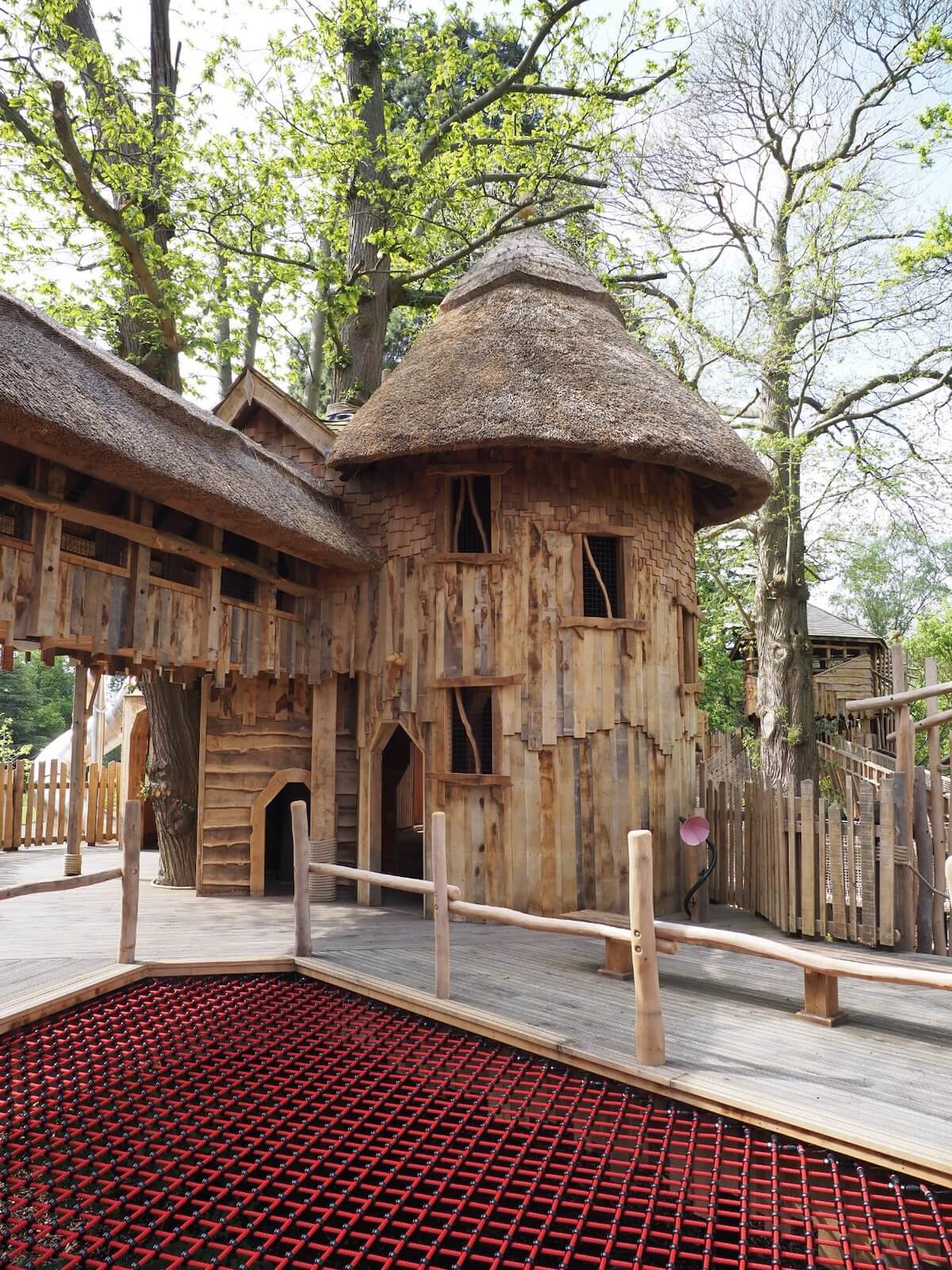 Giant open net and thatched wooden play at Windsor Great Park Adventure Play