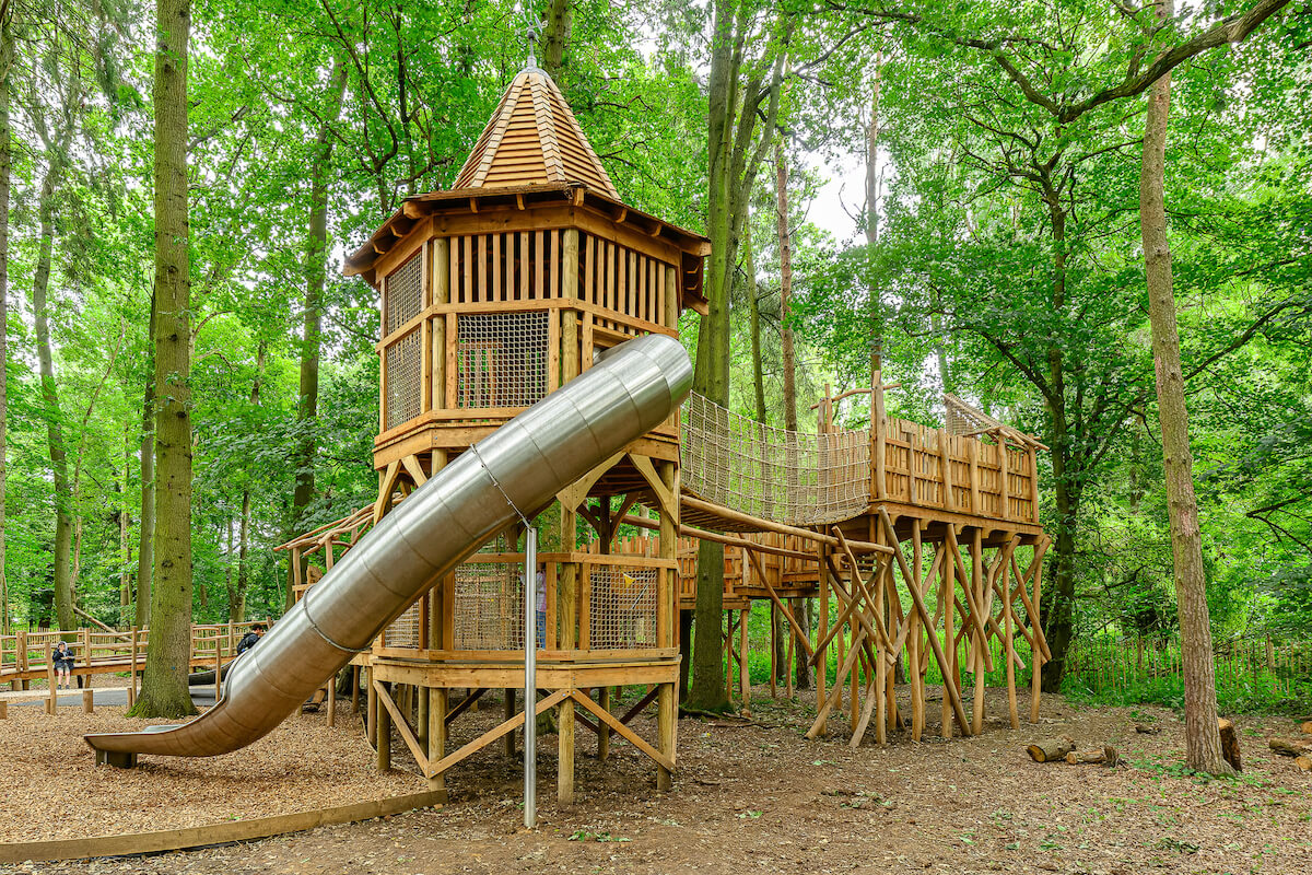 Wide view of the tower and slide at Hermits Hollow at Coombe Country Park with Adventure play by CAP.Co