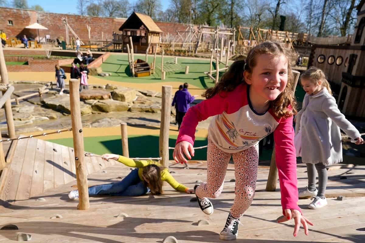 Climbing up the wall at The Lost Garden within Blenheim Palace Adventure Play by CAP.Co