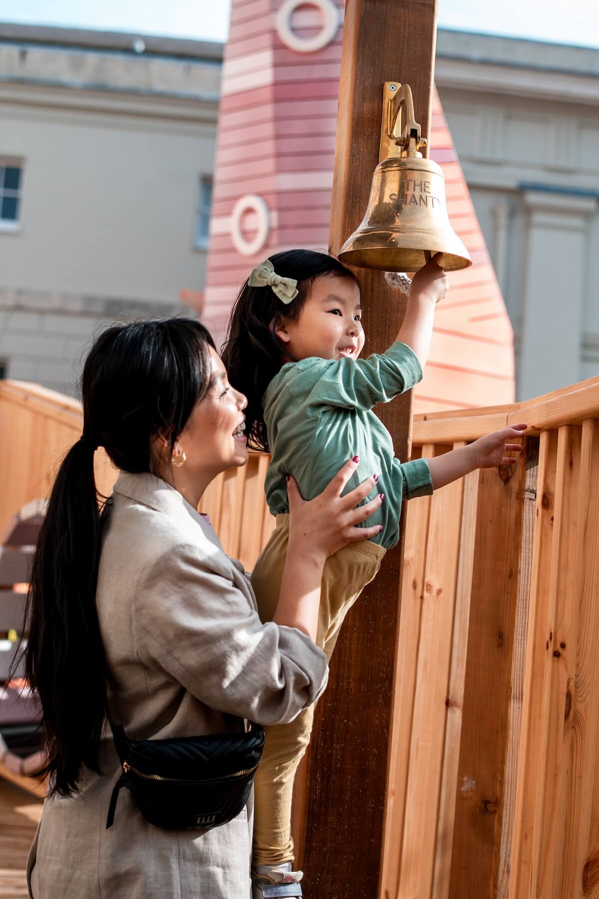 Reach up to ring the bell at The Cove at the National Maritime Museum Inclusive play by CAP.Co