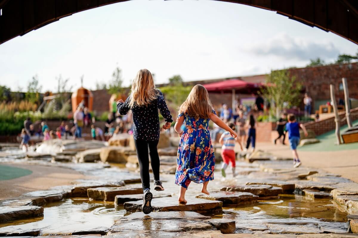 Skipping under the bridge at The Lost Garden within Blenheim Palace Adventure Play by CAP.Co