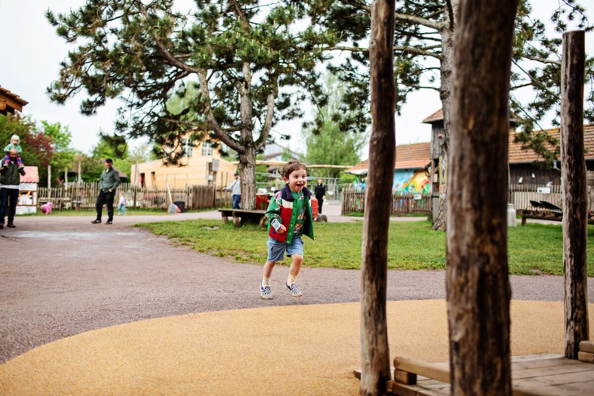 Running towards the Neos Homestead at Parc Sainte Croix with adventure play by CAP.CO Photography by Kev Foster