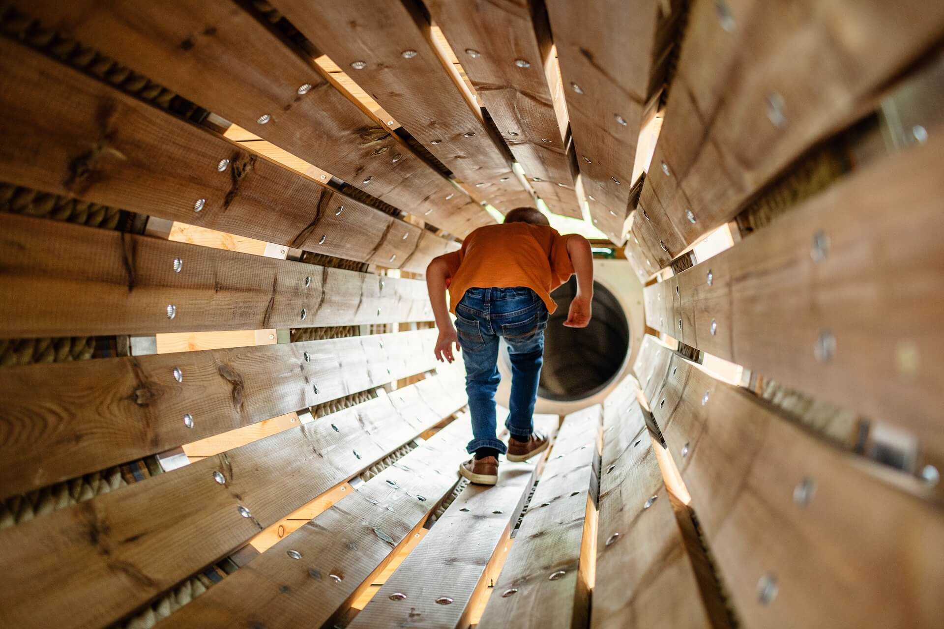 Crawling through the tunnel at Hopetown Darlington adventure play by CAP.CO with photography by Kev Foster