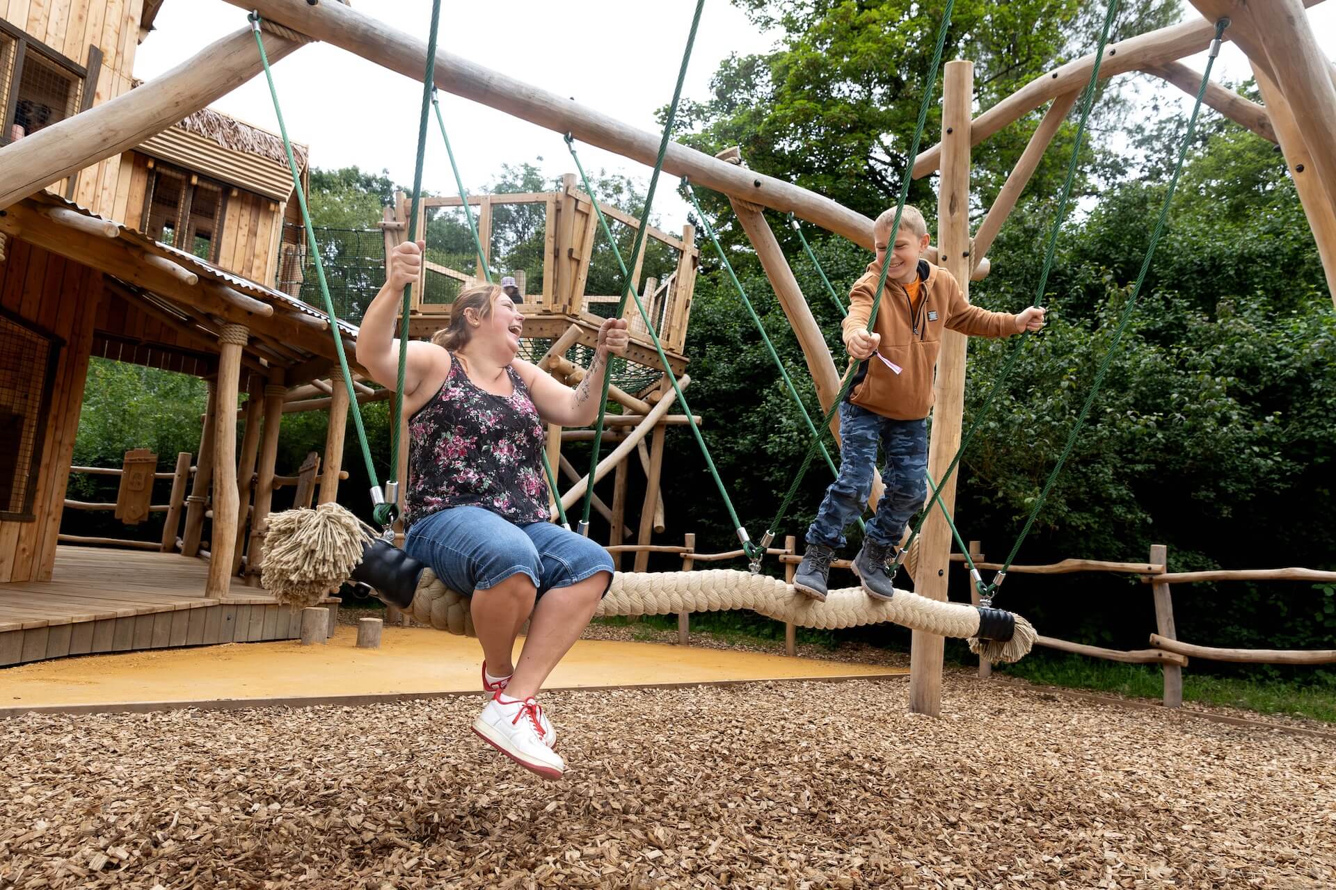 Families are swinging together at Explorers Basecamp at Bristol Zoo Project designed and built by CAP.CO