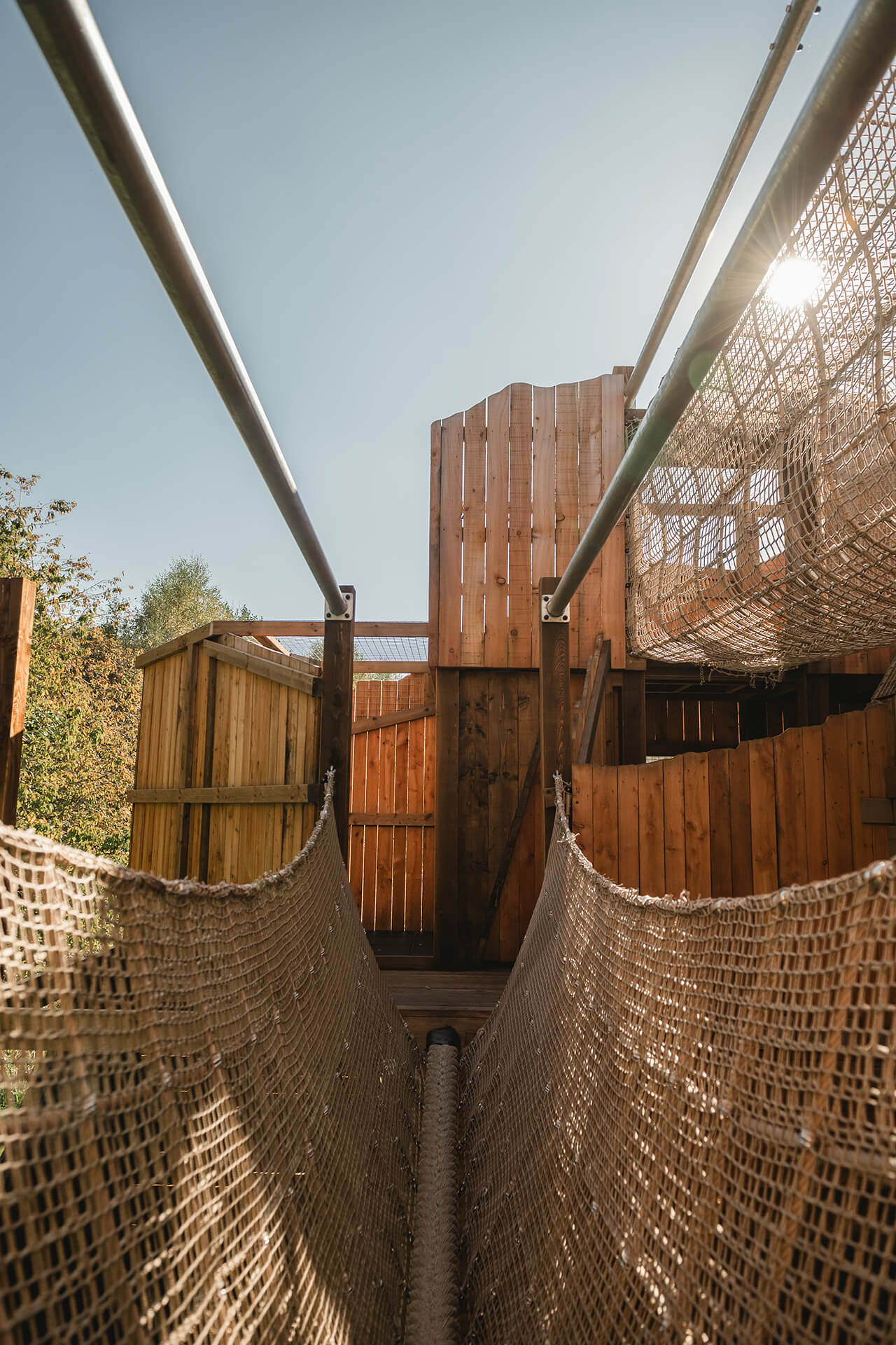 Image of a rope netting bridge at the CAP.CO built adventure playground at Almond Valley photography by Lindsey Mack