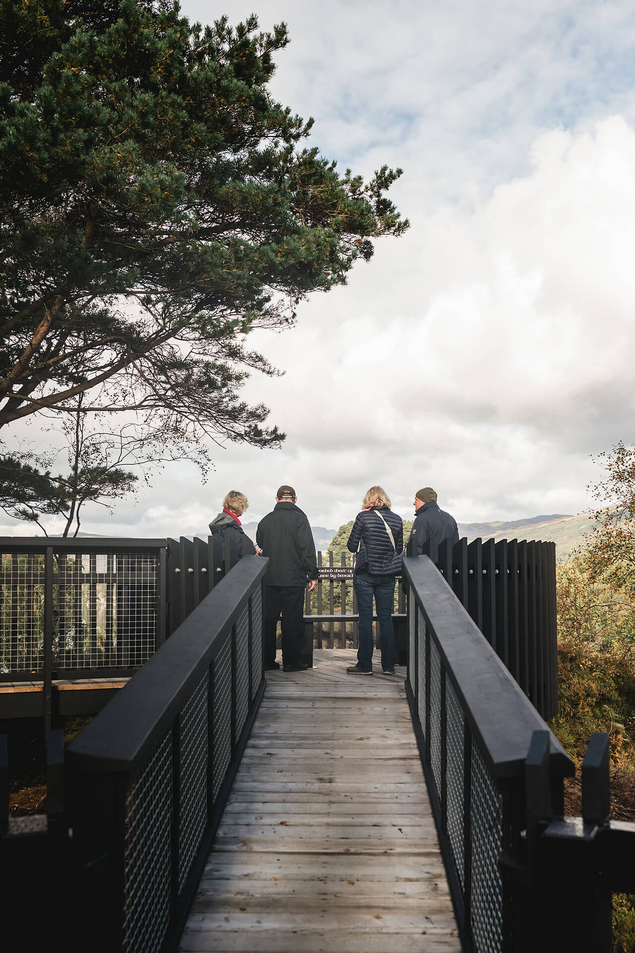 Image people standing on the CAPCO built Roderick Dhu lookout tower at Loch Katrine photography by Lindsey Mack