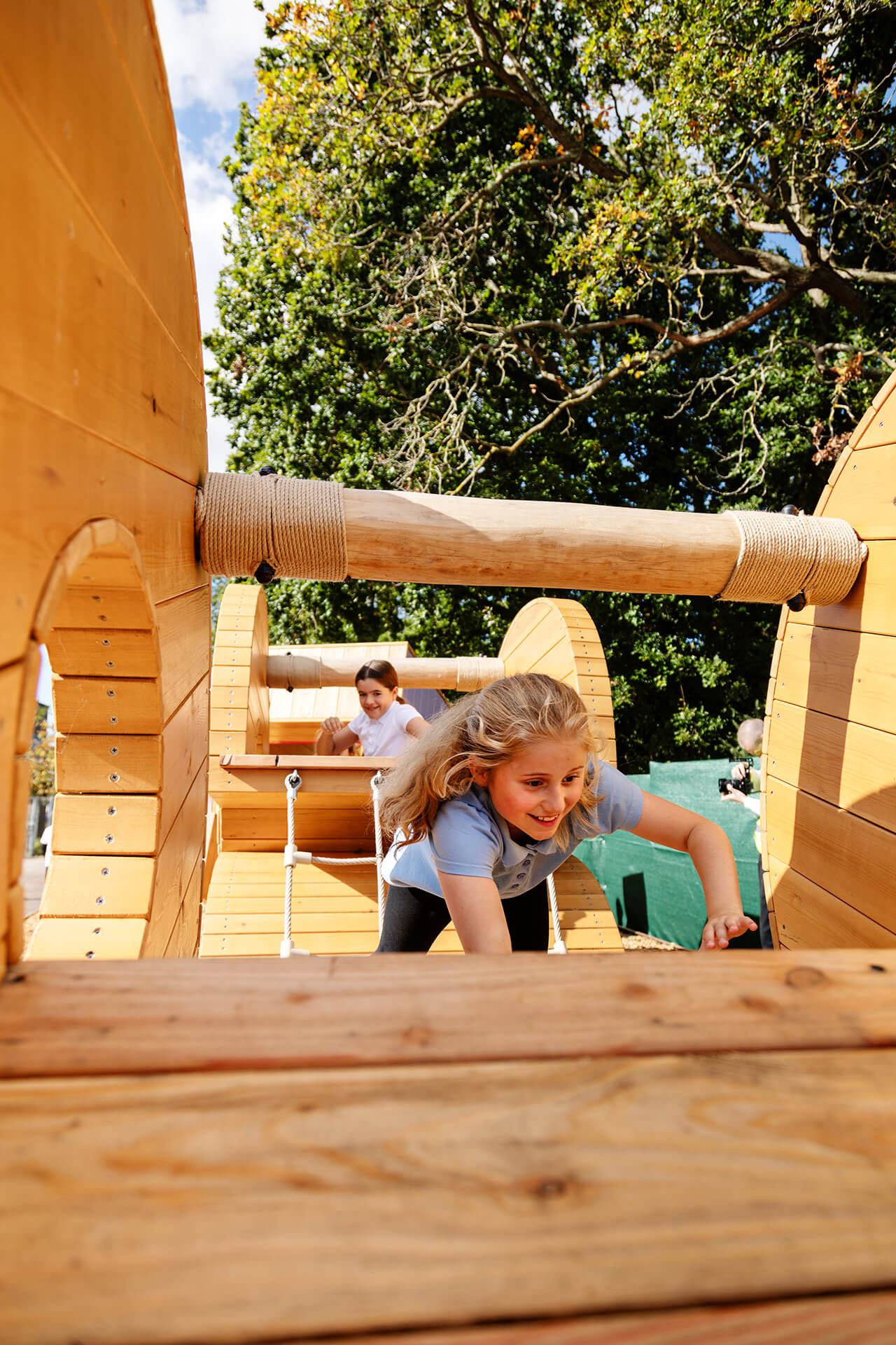 Children exploring and climbing through the play structure at the CAPCO built playground at Poringland photography by Kev Foster