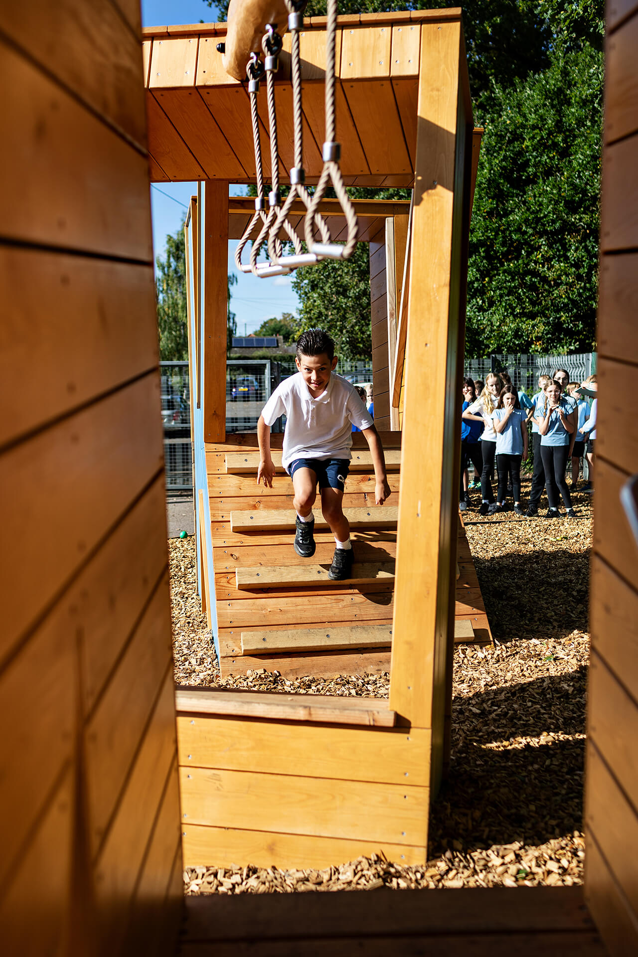 Poringland School Kindness playground built by CAPCO child running through letters photograpy by Kev Foster