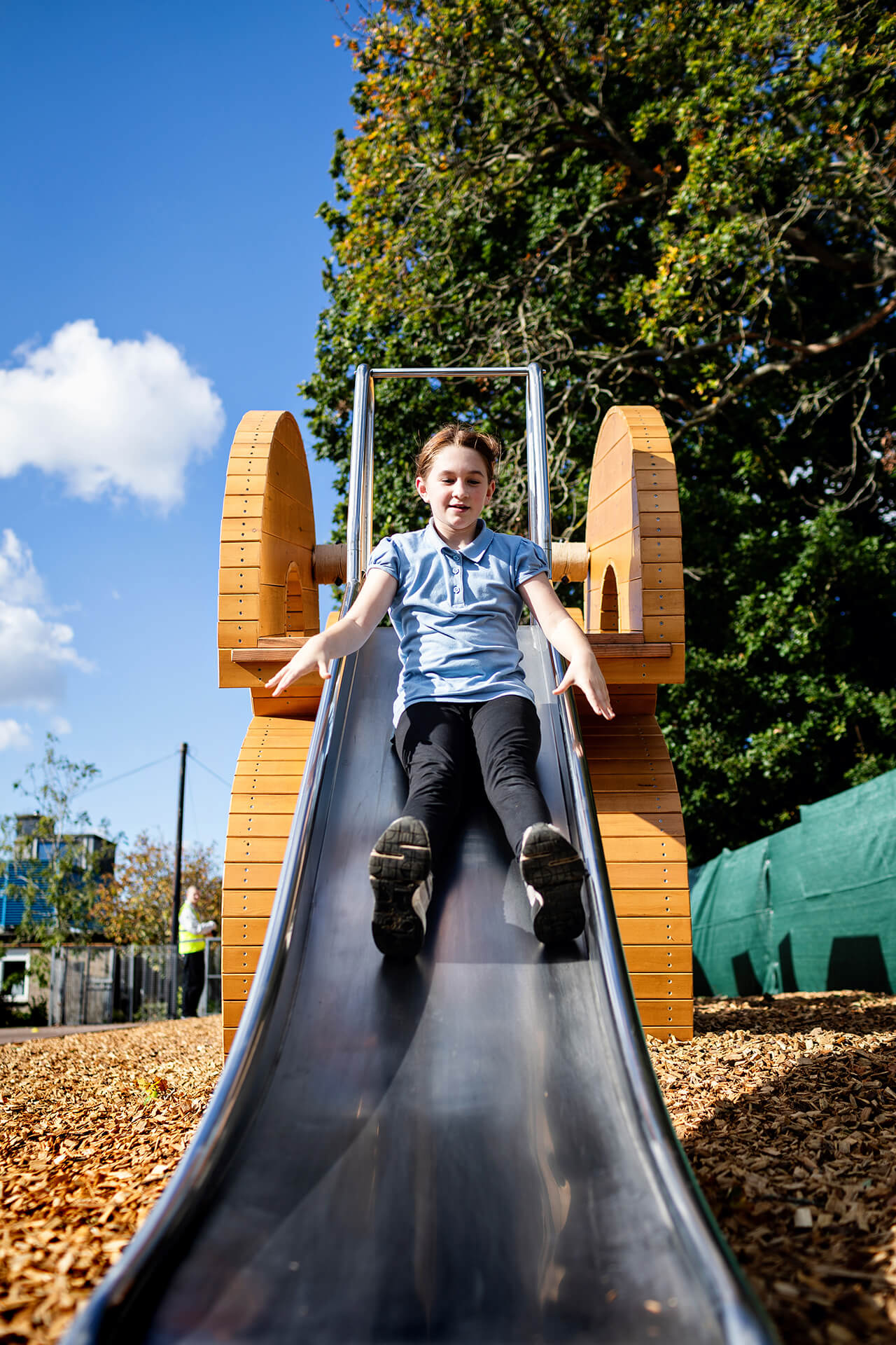 Poringland School Kindness playground built by CAPCO child sliding down the slide photography by Kev Foster