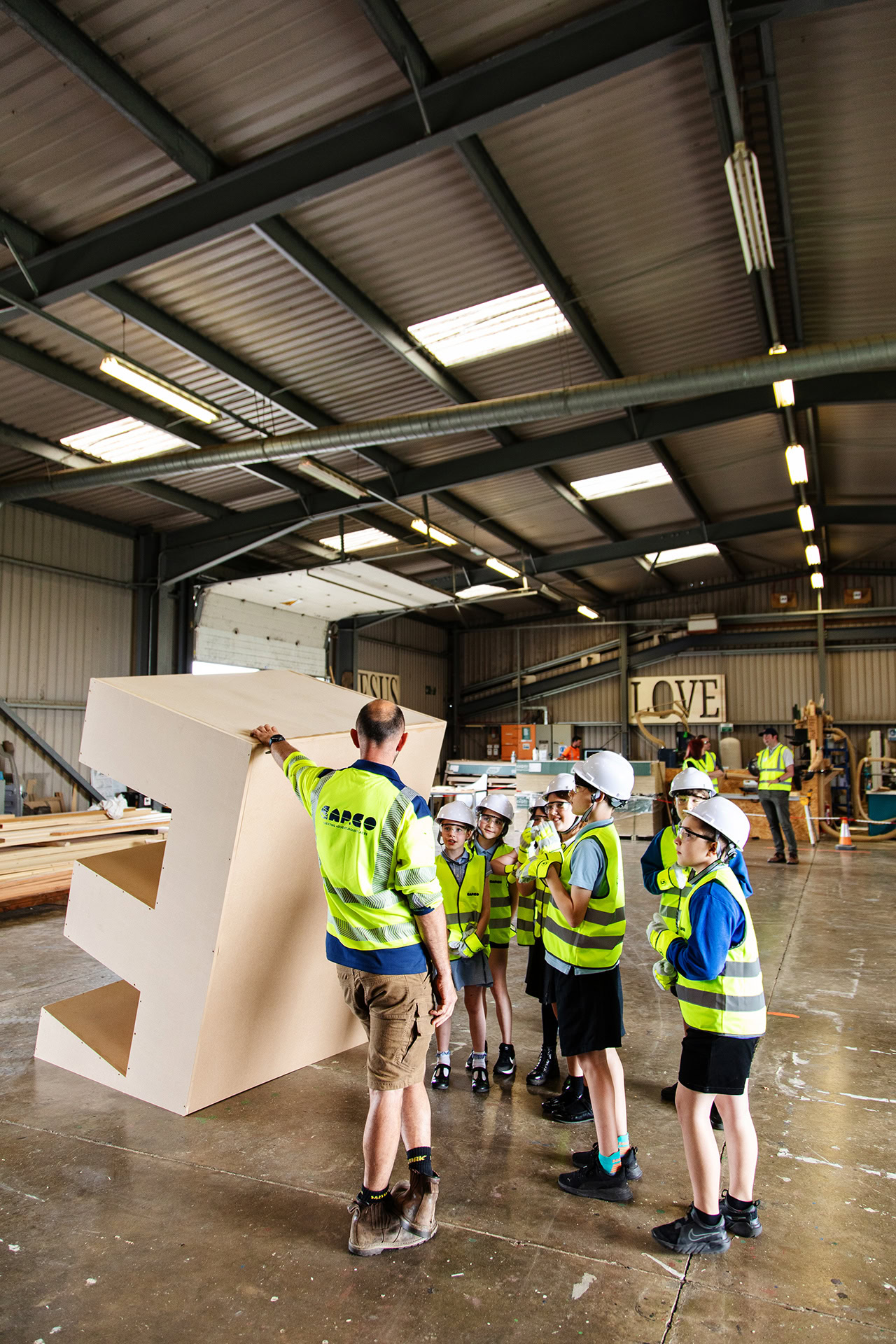 Poringland school visit to the CAPCO workshop jack is showing them a prototype of a play structure photography by Kev Foster
