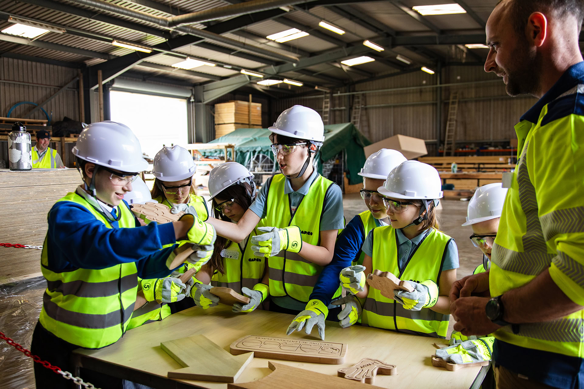 Poringland school visit to the CAPCO workshop jack showing them a build process in the workshop photography by Kev Foster