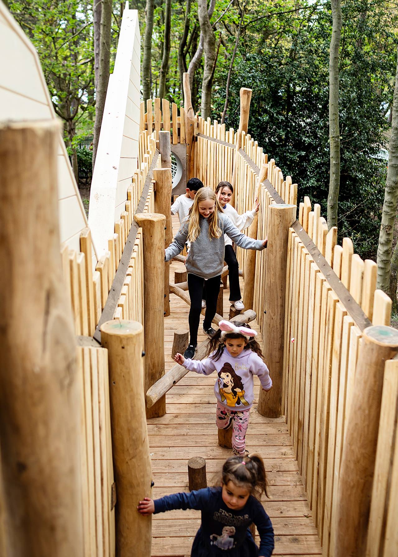Children making their way through the play structure at the Woodland Adventures playground at The Belfry Hotel built and designed by CAP.CO photography by Kev Foster