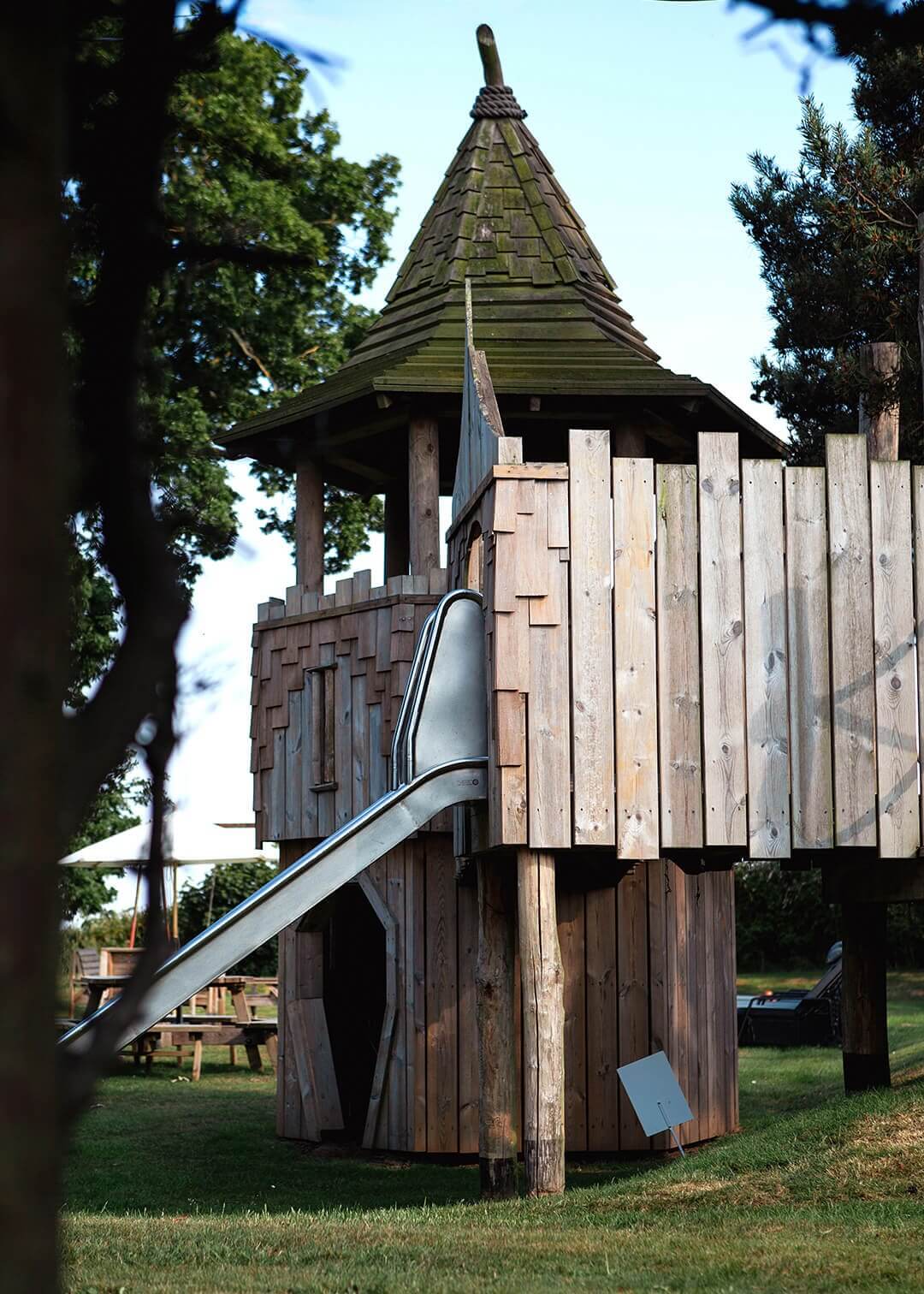 A slide coming off one for the platforms at Scarborough Hill Country Inn Hotel pine tower playground built and designed by CAPCO photography by George Browne