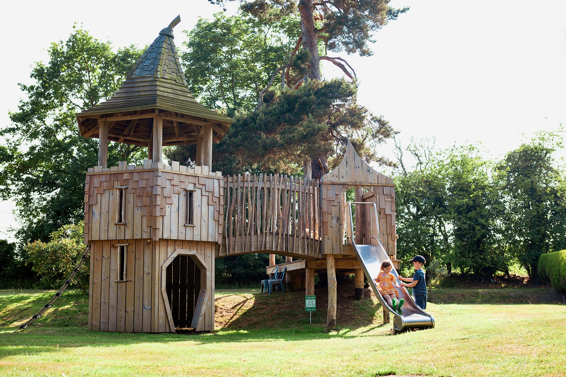 Children playing on the slide at the Scarborough Hill Country Inn Hotel pine tower playground built and designed by CAPCO photography by George Browne