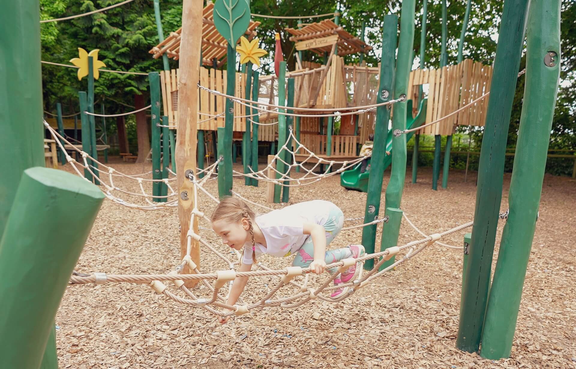 Clambering across the rope spiders web at Joshis Jungle Playground at Howletts Wild Animal Park by CAP.CO Creating Adventurous Places