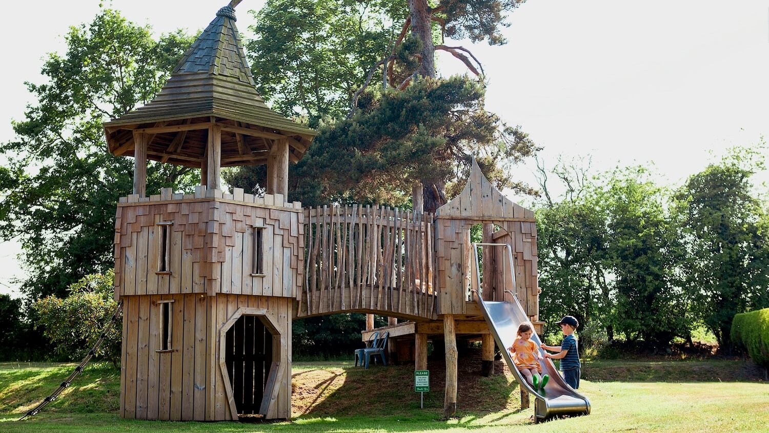 Children playing on the slide at the Scarborough Hill Country Inn Hotel pine tower playground built and designed by CAPCO photography by George Browne
