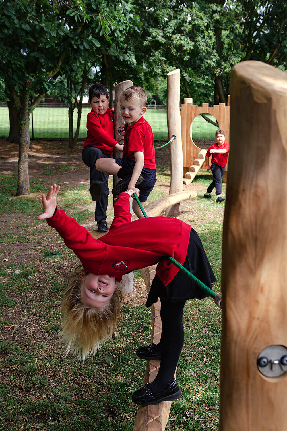 Children enjoying a natural ground play trail at Fen Drayton Primary School, built by CAP.CO