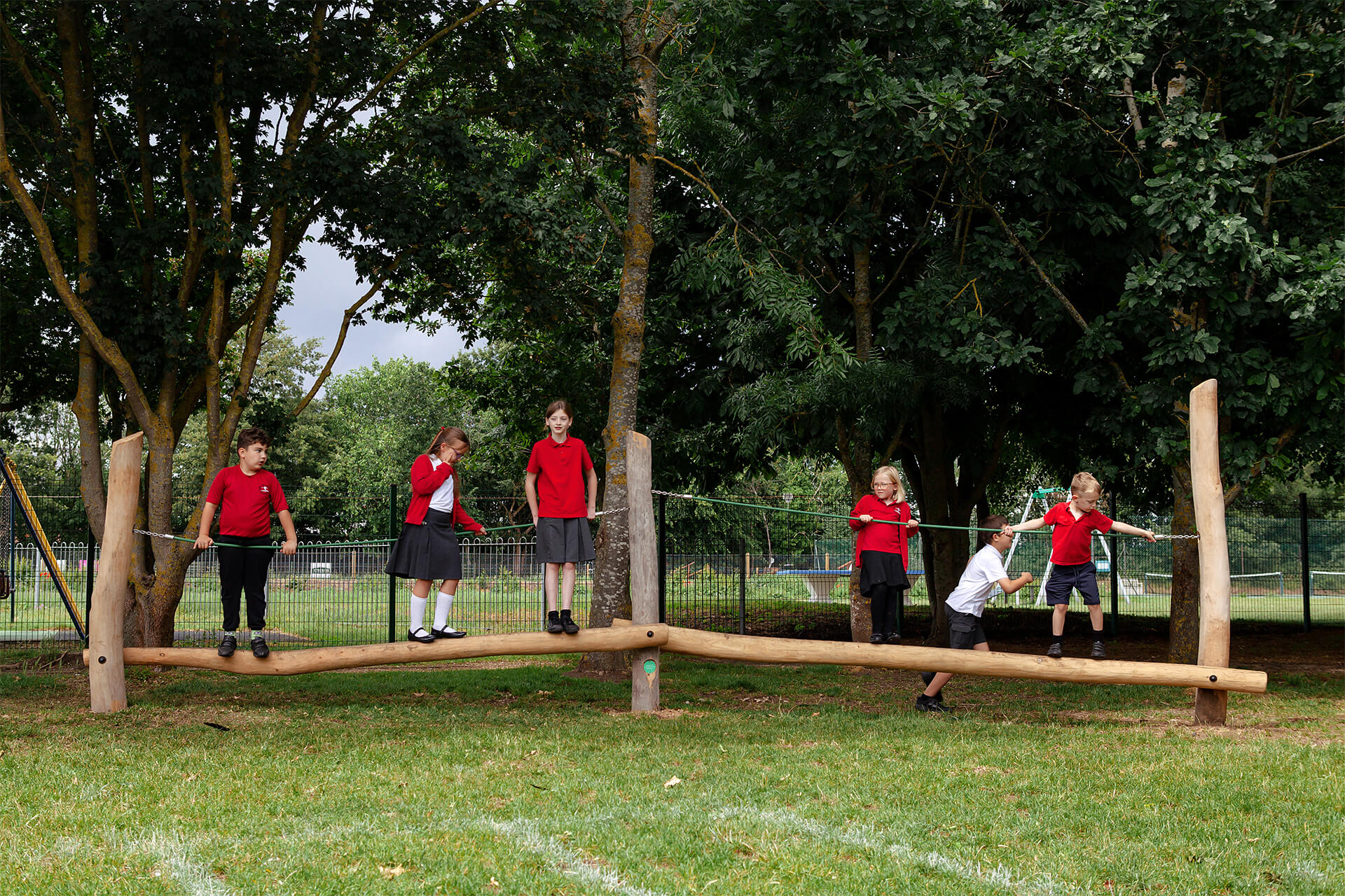 Pupils enjoying outdoor play on a CAP.CO school playground trail at Fen Drayton Primary School