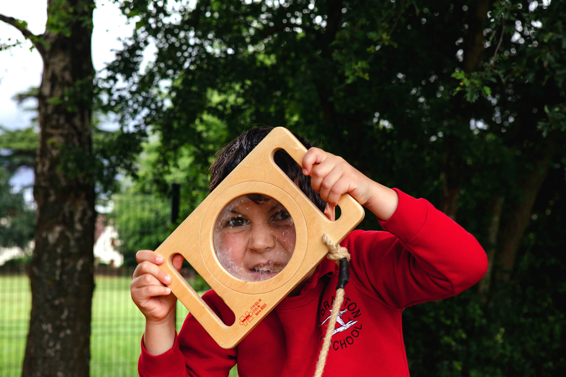 Schoolchildren having fun on a bespoke CAP.CO playground at Fen Drayton Primary School