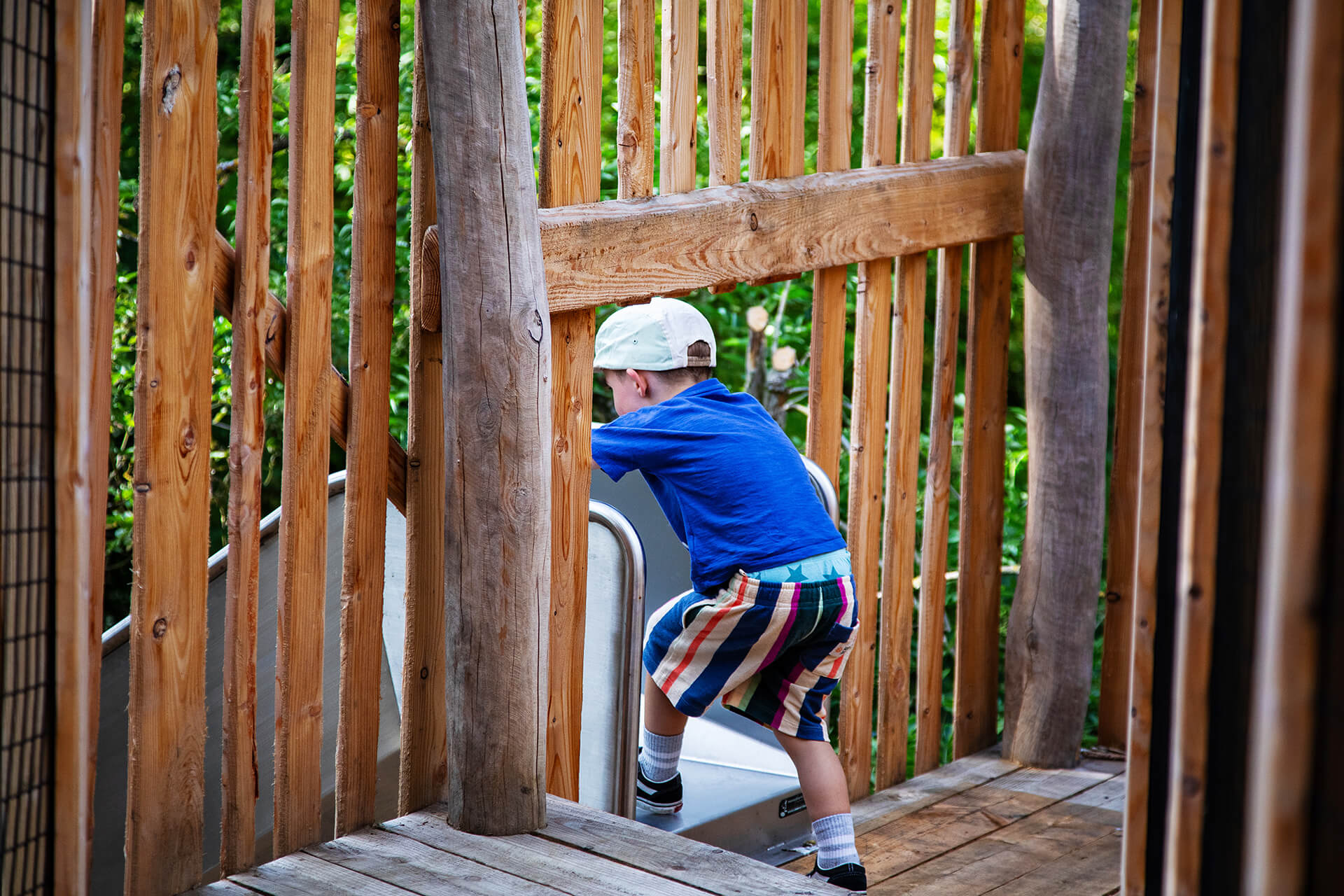 A child about to go down ther slide at Guildenacre adventure playground at Helmingham designed and built by CAP.CO, photography by Kev Foster