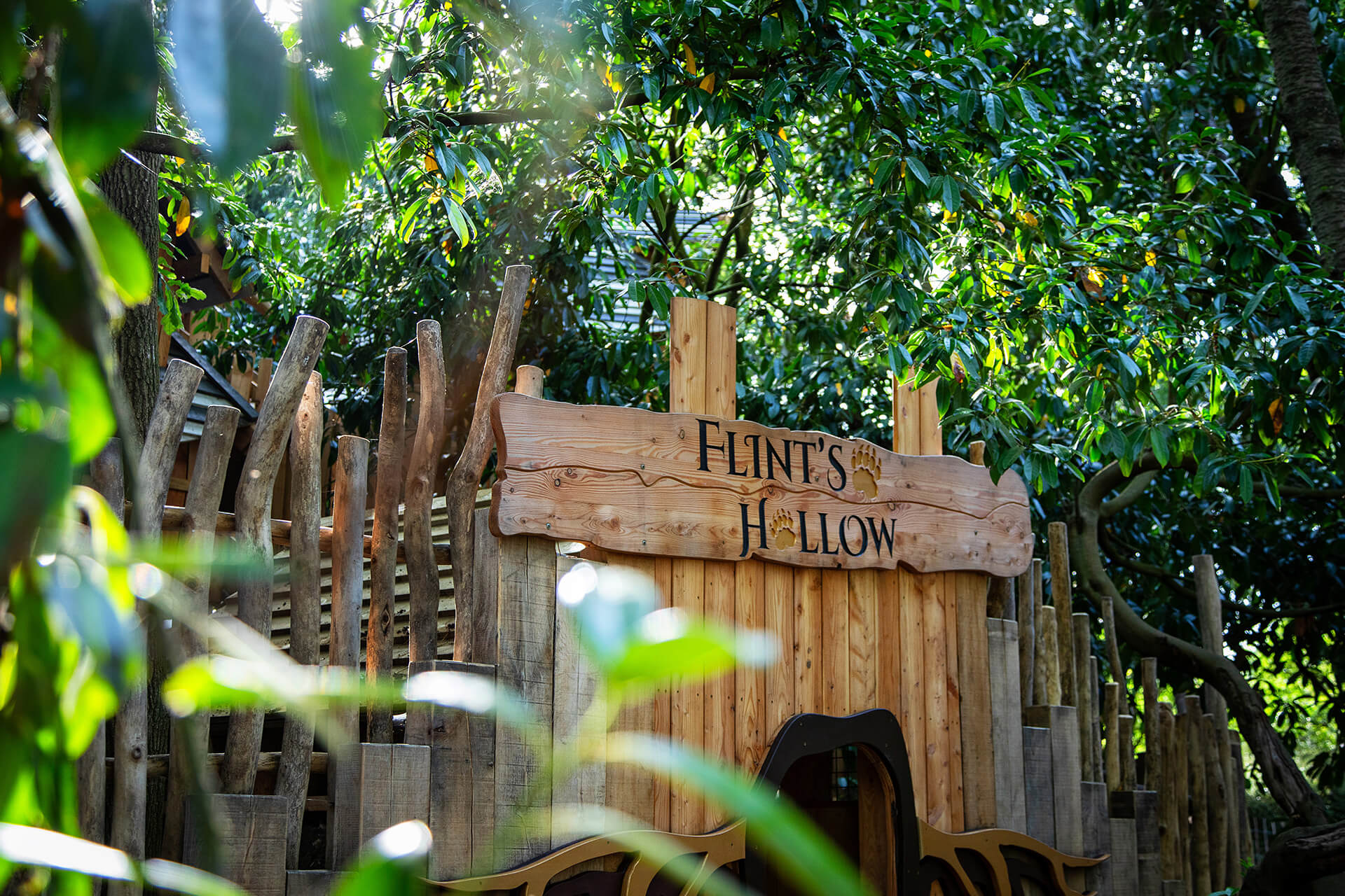 Hollow badger-themed play structure with striped turrets and burrow tunnels by CAP.CO, photography by Kev Foster