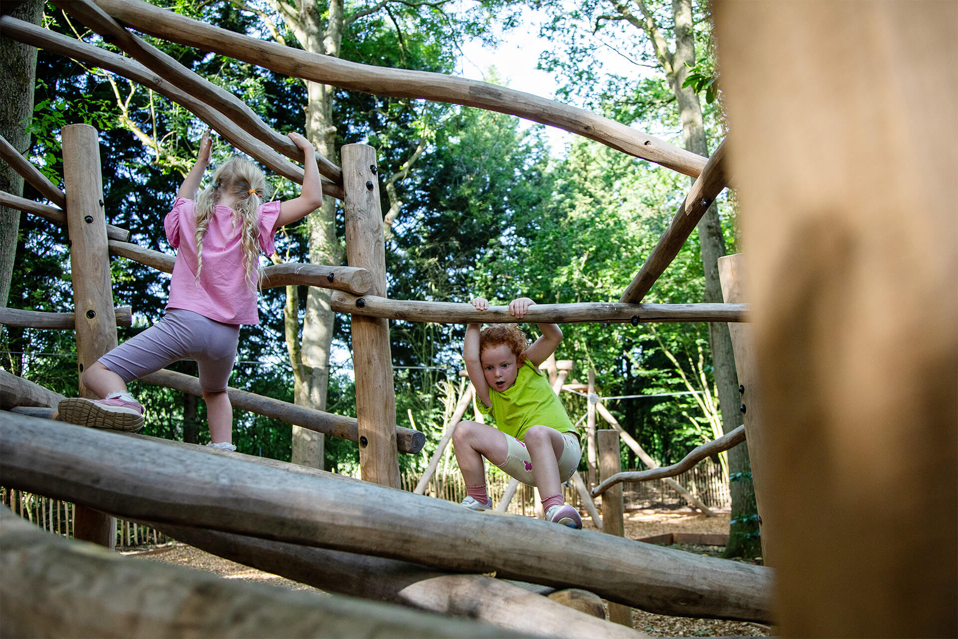 Ground-level adventure course with logs and beams in the Ember Den zone by CAP.CO, photography by Kev Foster