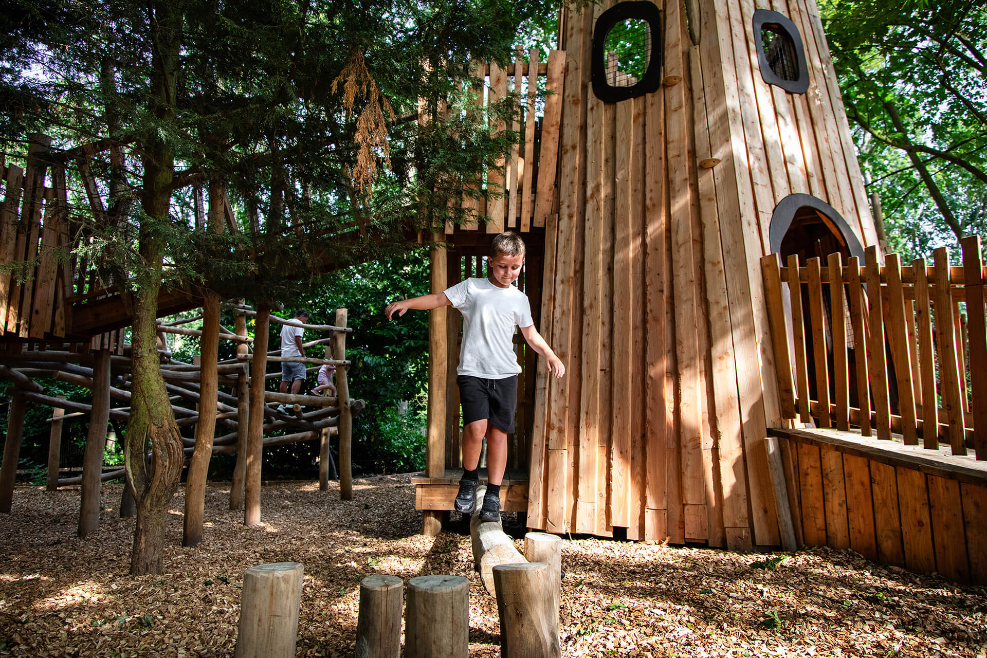 Older children navigating exploratory play trails in the Ember Den by CAP.CO, photography by Kev Foster