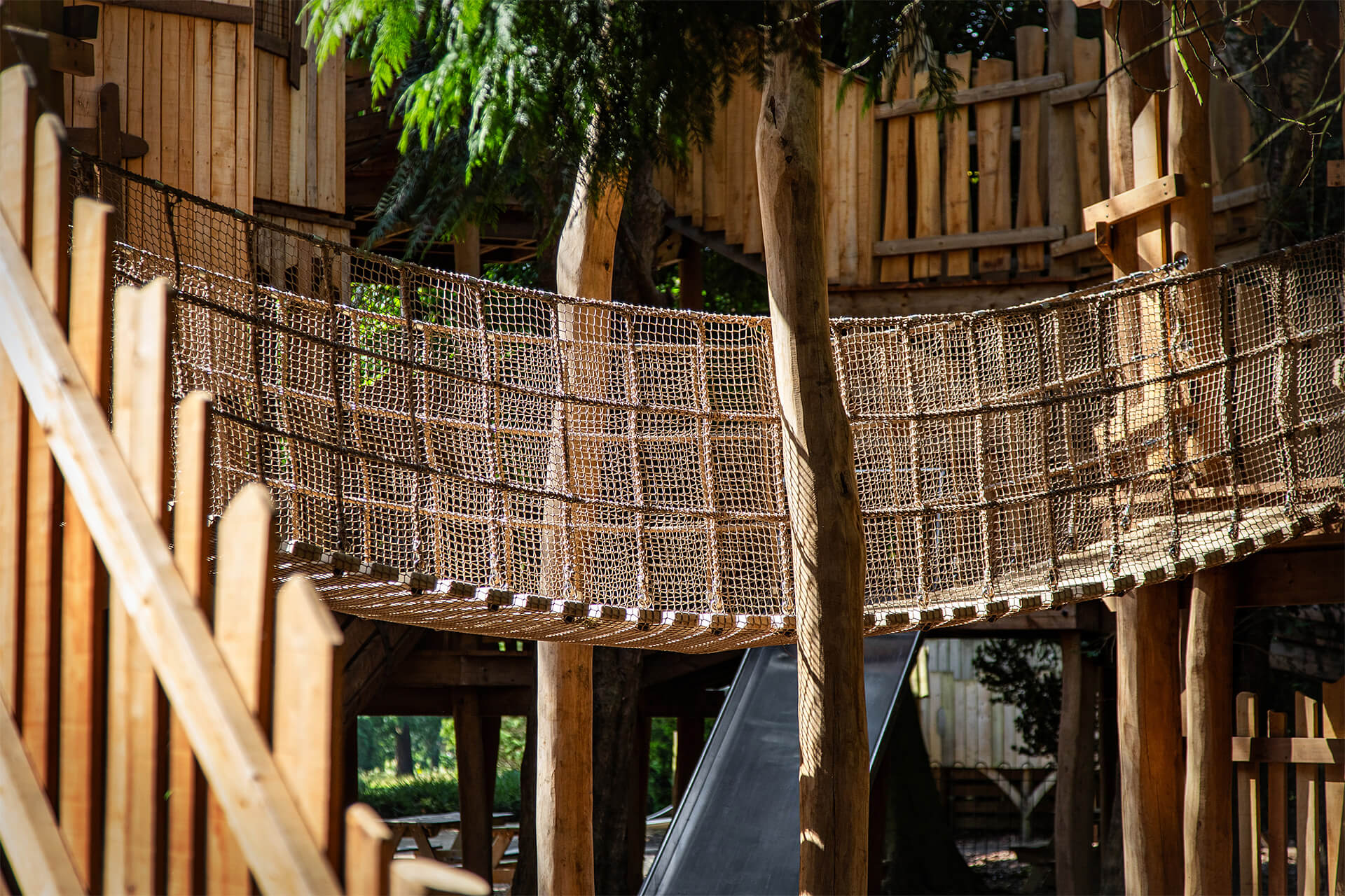 A cargo net rope bridge at The Sky Maze adventure playground at Cotswold Wildlife Park, designed and built by CAP.CO, photography by Kev Foster