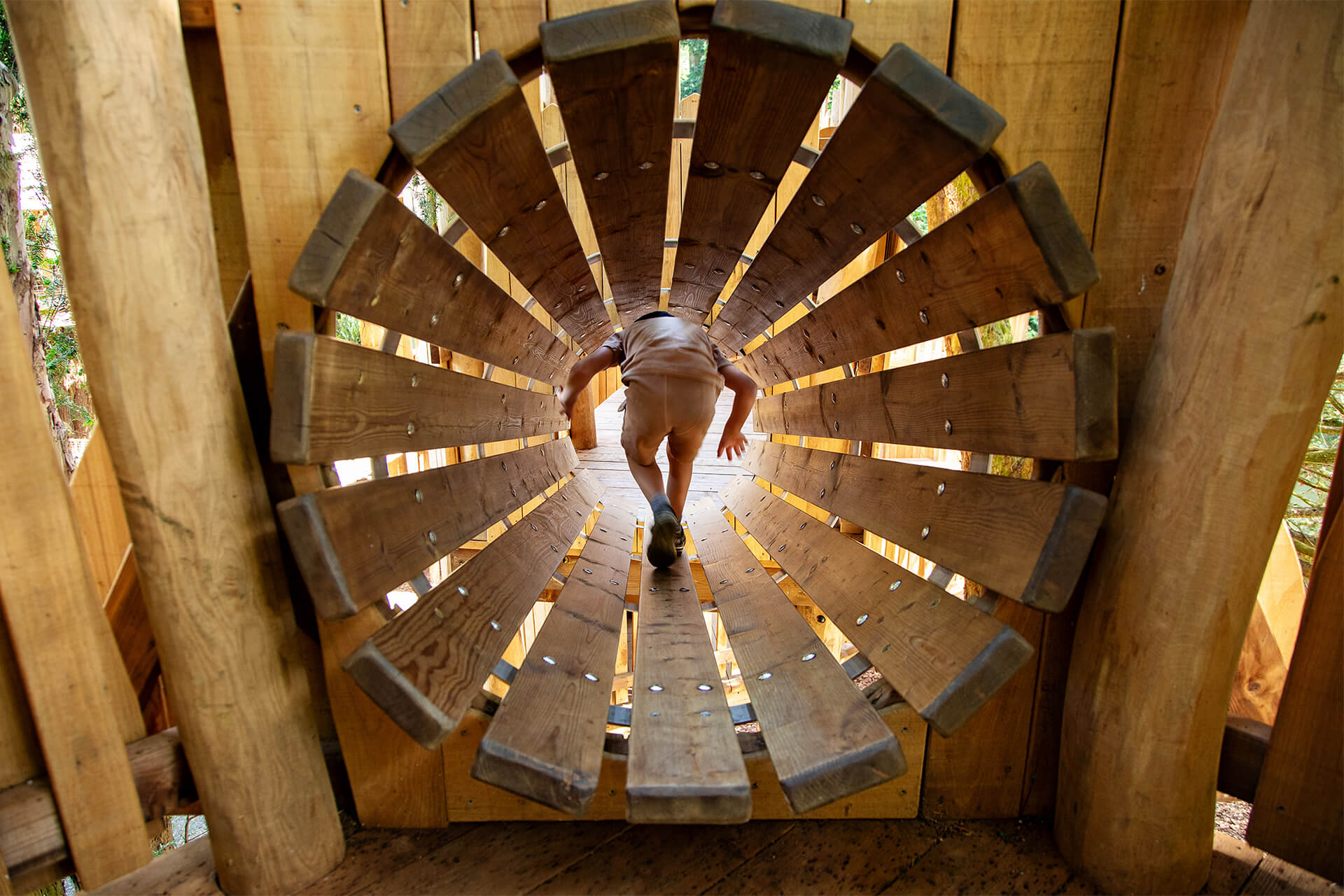 Navigating the crawl tunnels at The Sky Maze adventure playground at Cotswold Wildlife Park, designed and built by CAP.CO, photography by Kev Foster